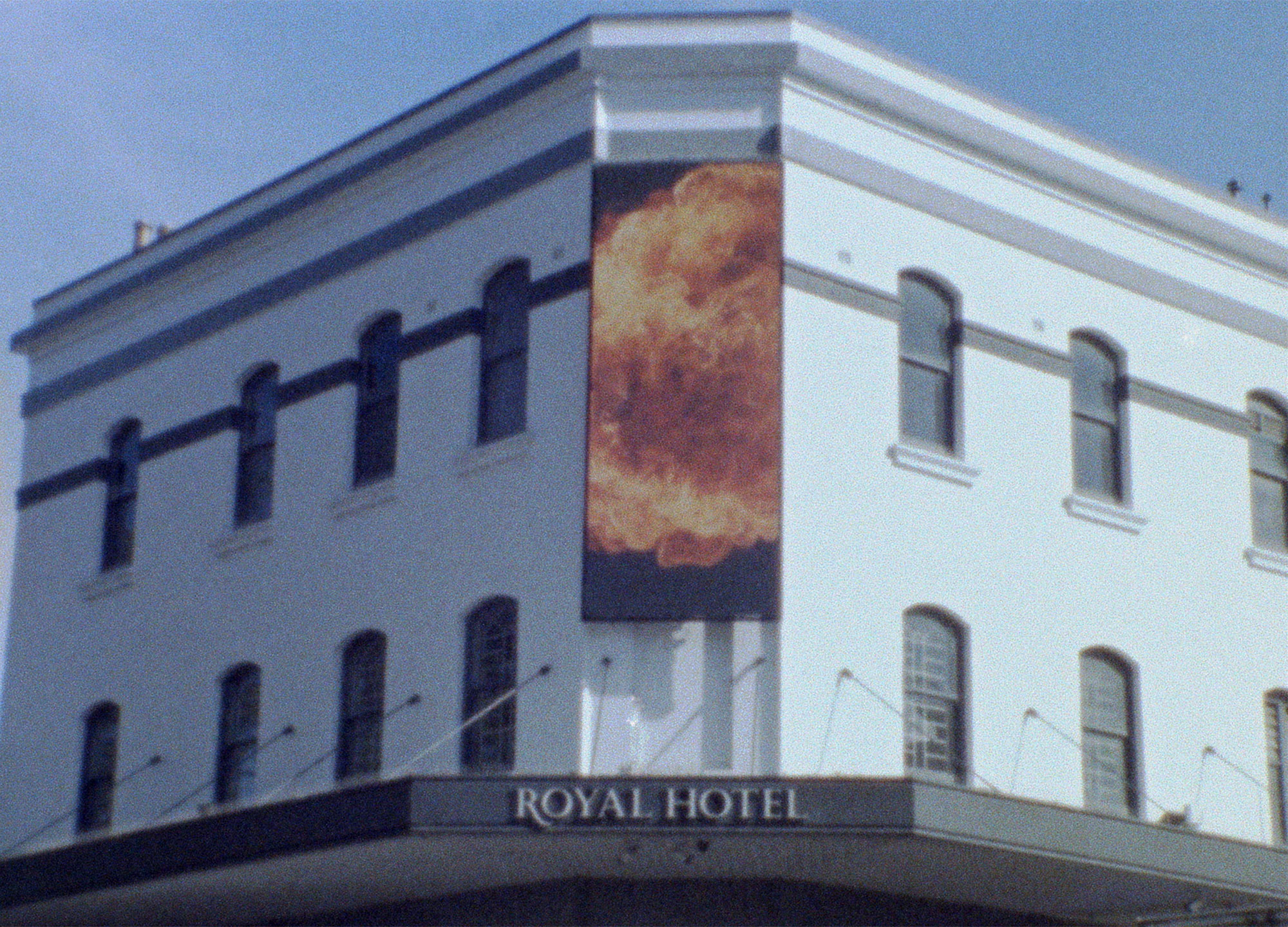 The Royal Hotel in Granville bearing a digital billboard that has the image of an explosion playing on it
