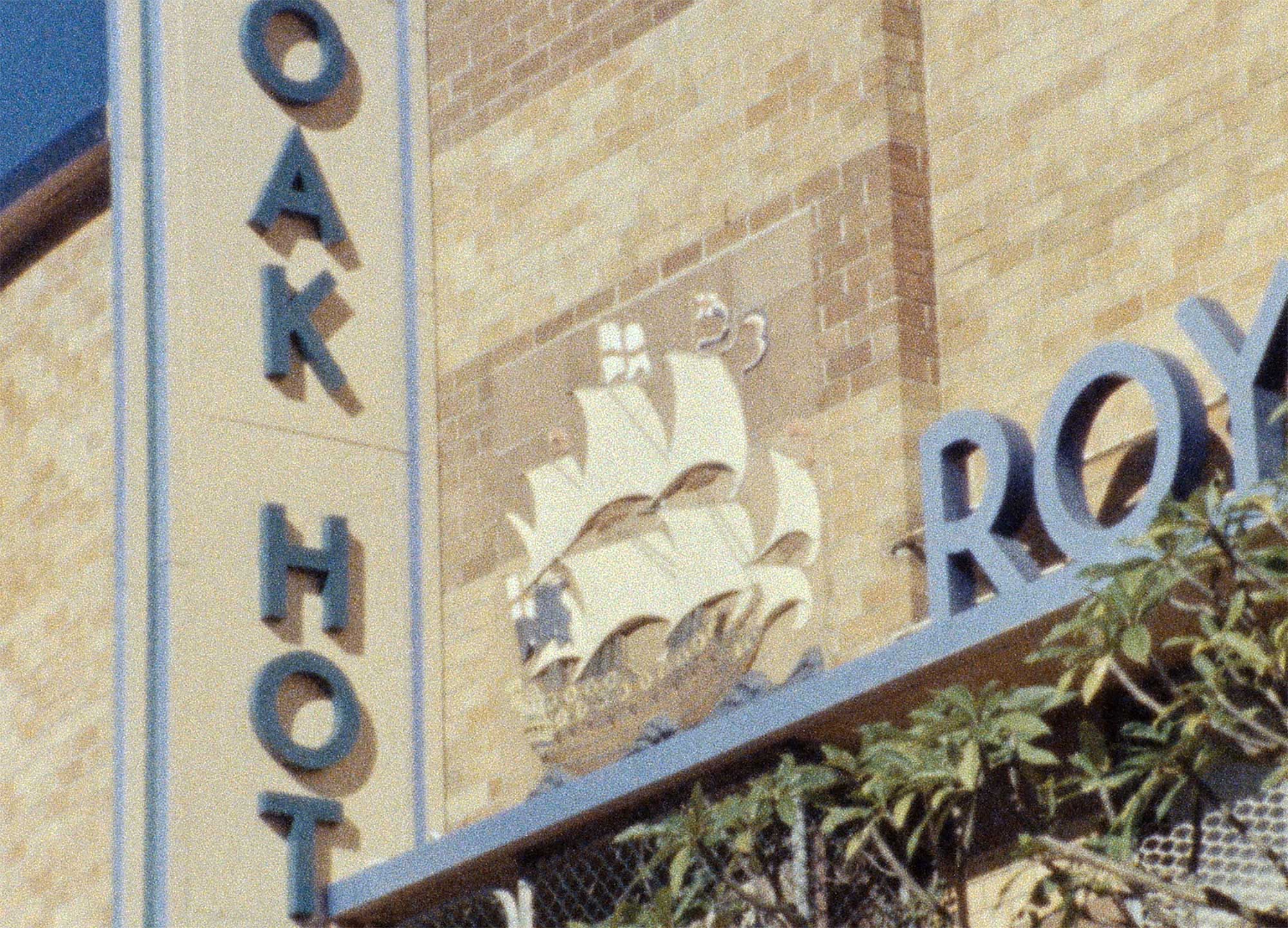 Film still depciting a detail of the facade of the Royal Oak Hotel in Lidcombe, NSW